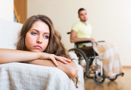 Quarrel in family with handicapped husband at backgroundの写真素材