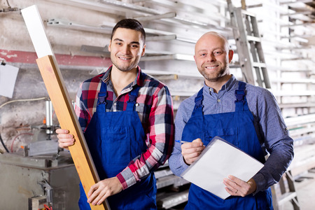 manager and worker approving work at PVC windows factoryの写真素材