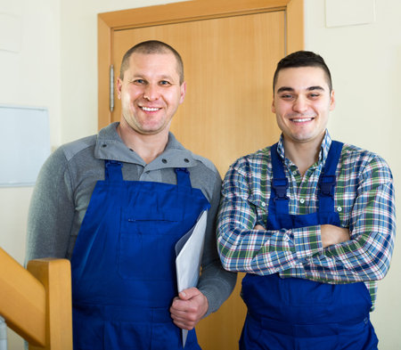 Portrait of two professional workers in uniform smiling indoorの写真素材