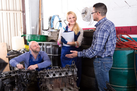 Client has come to an engine maintenance workshop to see how his engine repair is going on
