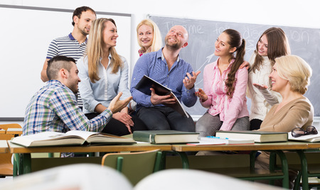 Professor consulting a different age students at a extension courses in classroomの写真素材