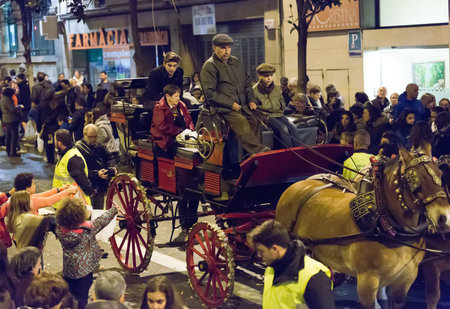 BARCELONA, SPAIN - MARCH 3, 2015: People handing out caramels from carriage. Sant Medir festa -...