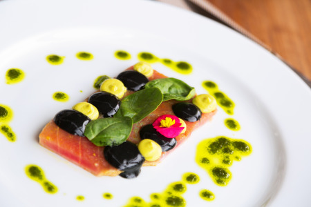 tuna steak with sauce on plate  at restaurant tableの写真素材