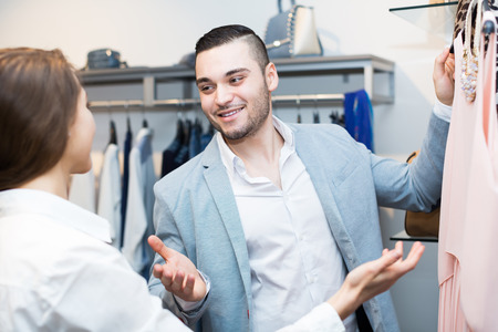 Positive customer consulting with female shop assistantの写真素材