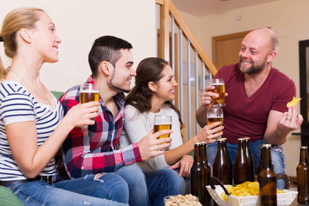 Joyful friends having fun at house party togetherの写真素材