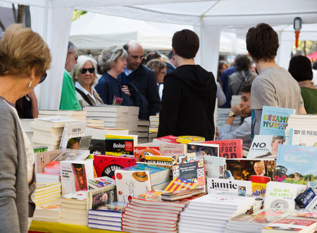 BARCELONA, SPAIN - APRIL 23, 2015:  Books on street stalls in Barcelona, Catalonia.Books and red roses - symbols of Sant Jordi feast in Cataluniaのeditorial素材