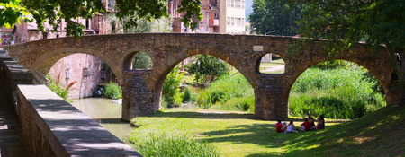 VIC, SPAIN - JUNE 9, 2015: Old stone bridge over  river  in Vic.  Spainのeditorial素材