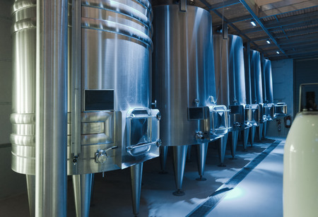 Row of contemporary  large stell barrels in winemakerの写真素材
