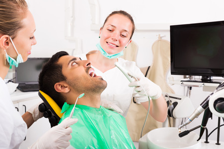 Young man patient checking the teeth on computer equipmentの写真素材