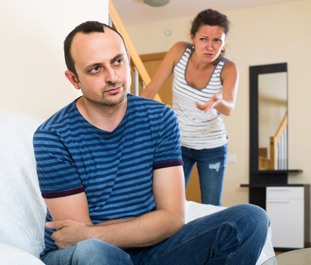 Upset wife and furious american husband discussing divorceの写真素材