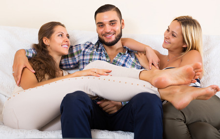 Portrait of two smiling charming girls with attractive boyfriendの写真素材