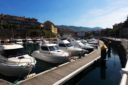 LLANES, SPAIN - JULY 3, 2015: Docked yachts lying at port side of Llanesのeditorial素材