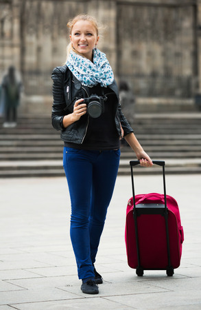 Europenian young girl taking pictures of sights at city excursionの写真素材