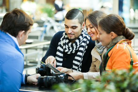 Group of young travellers checking direction in map at street cafe. Selective focusの写真素材