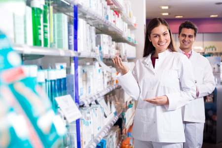 Portrait of two cheerful friendly pharmacists working in luxury pharmacyの写真素材