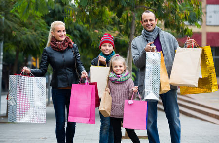 Smiling family with school age children enjoying shopping tourの写真素材