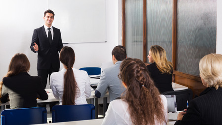Happy young professor and professionals at extension business coursesの写真素材