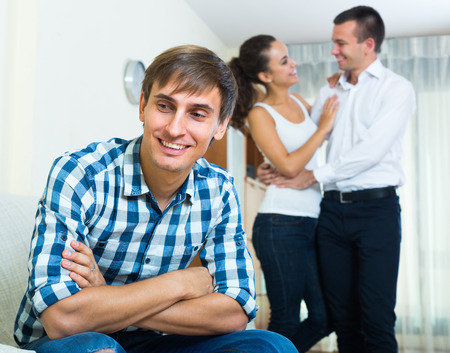 Young guy in love triangle: his beloved woman prefers rivalの写真素材