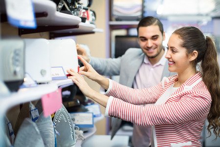Smiling young customers purchasing toaster in domestic appliances sectionの写真素材