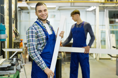 Happy adult man smiling while working in the factoryの写真素材