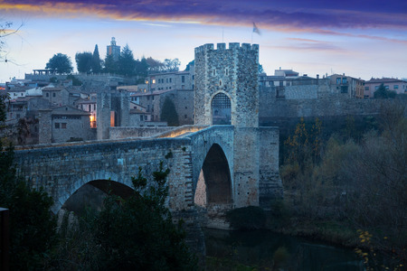 Morning viwe of medieval fortifications and bridge. Besalu, Cataloniaのeditorial素材