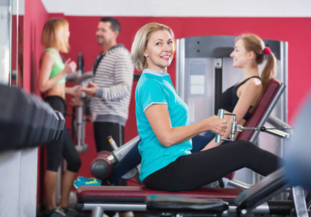 Active positive glad people  weightlifting training in modern health club