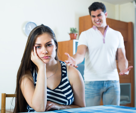 Furious man and longhaired girl during home quarrelの写真素材