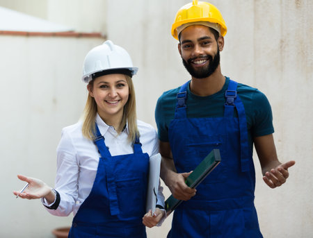 Constructor and professional builder with spirit level at site