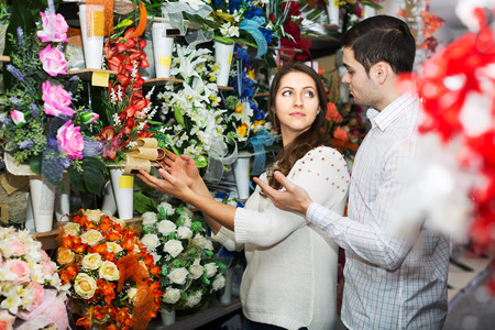 Man and woman choosing a bouquet at a flower shopの写真素材