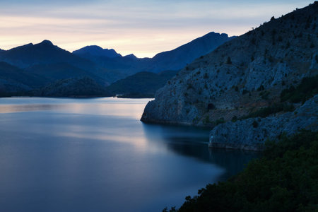 mountains lake in summer sunrise. Barrios de Luna reservoir