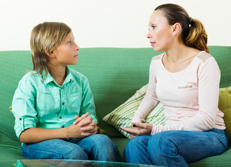 teenager son and  mother having serious talkingの写真素材