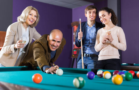 Elderly middle class people having pool game in billiard club