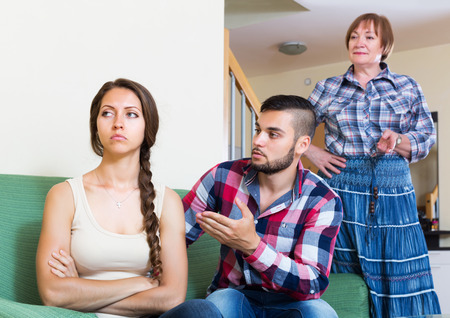 Mature mother having conflict with their upset adult childrenの写真素材