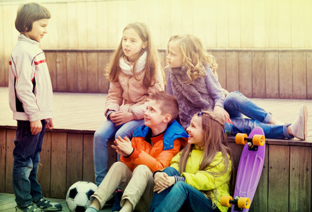 Group of children portrait with ball and skateboard outdoorsの写真素材
