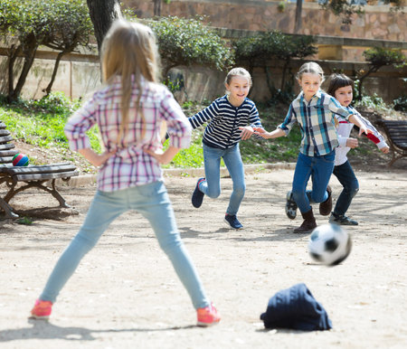 Junior kids playing street football outdoors in spring dayの写真素材