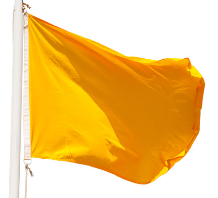 waving yellow flag isolated on the white backgroundの写真素材