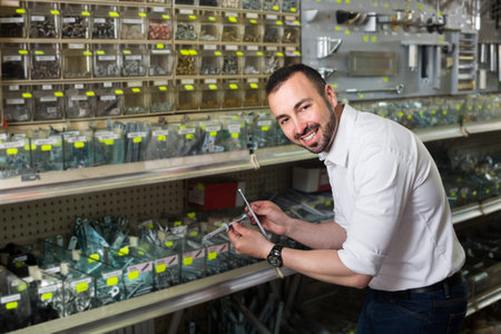 Portrait of man selecting rawlplug in household department