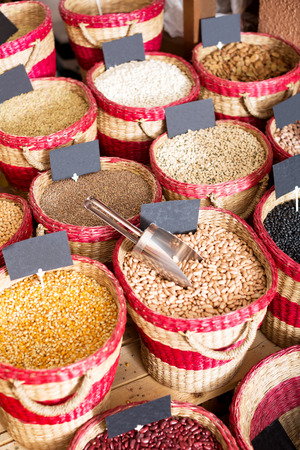 Closeup view on various beans in baskets selling on marketの写真素材