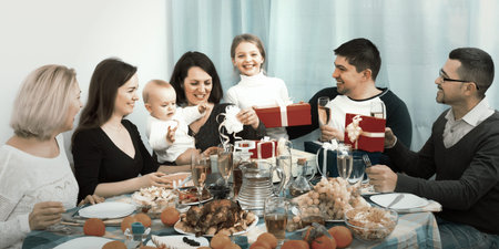 Multigenerational family congratulating happy girl with her birthday at homeの写真素材