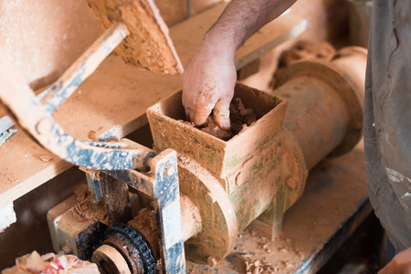 Closeup view on clay forming machine in ceramics studioの写真素材