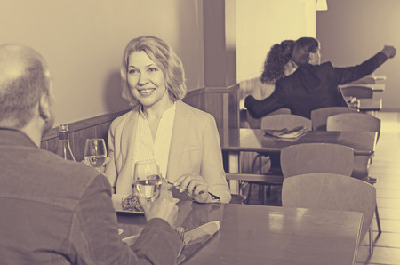 man and woman spending time together in restaurantの写真素材
