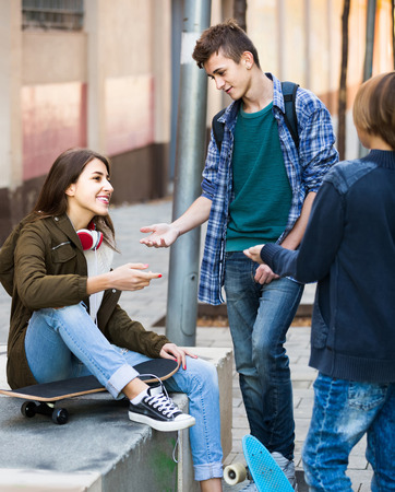 Group of happy european teenage friends chatting and having fun outdoorの写真素材