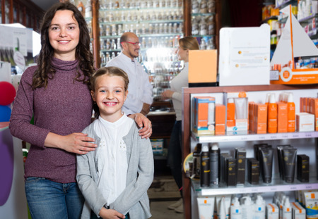 ?cheerful smiling latino pharmacist helping customersの写真素材