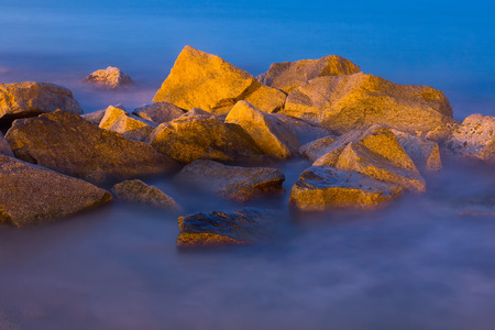 Beautiful waterscape with rocks in river stream mistの写真素材