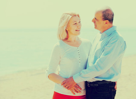 loving mature couple against sea