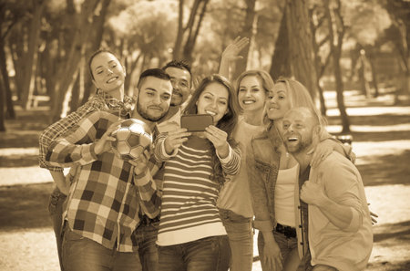 Group of friends taking pictures together at countryside
