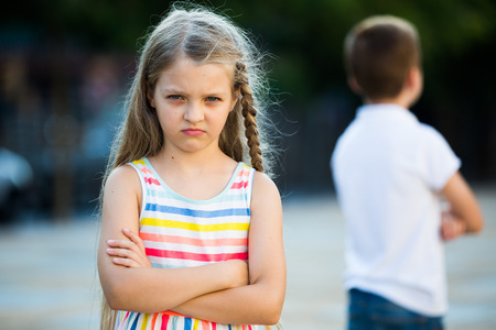 sad girl in preschool age having problem with friend outdoors in parkの写真素材