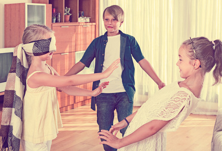 smiling children playing at Blind man bluff indoorsの写真素材