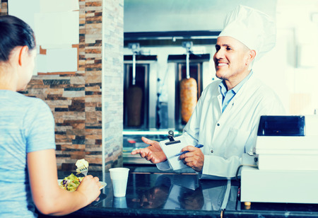 man chef  giving order with kebabの写真素材