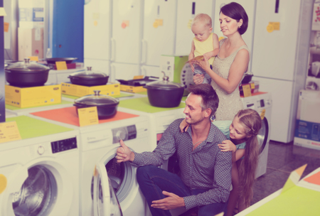 Happy dad with girl together in elementary school age in household hypermarketの写真素材